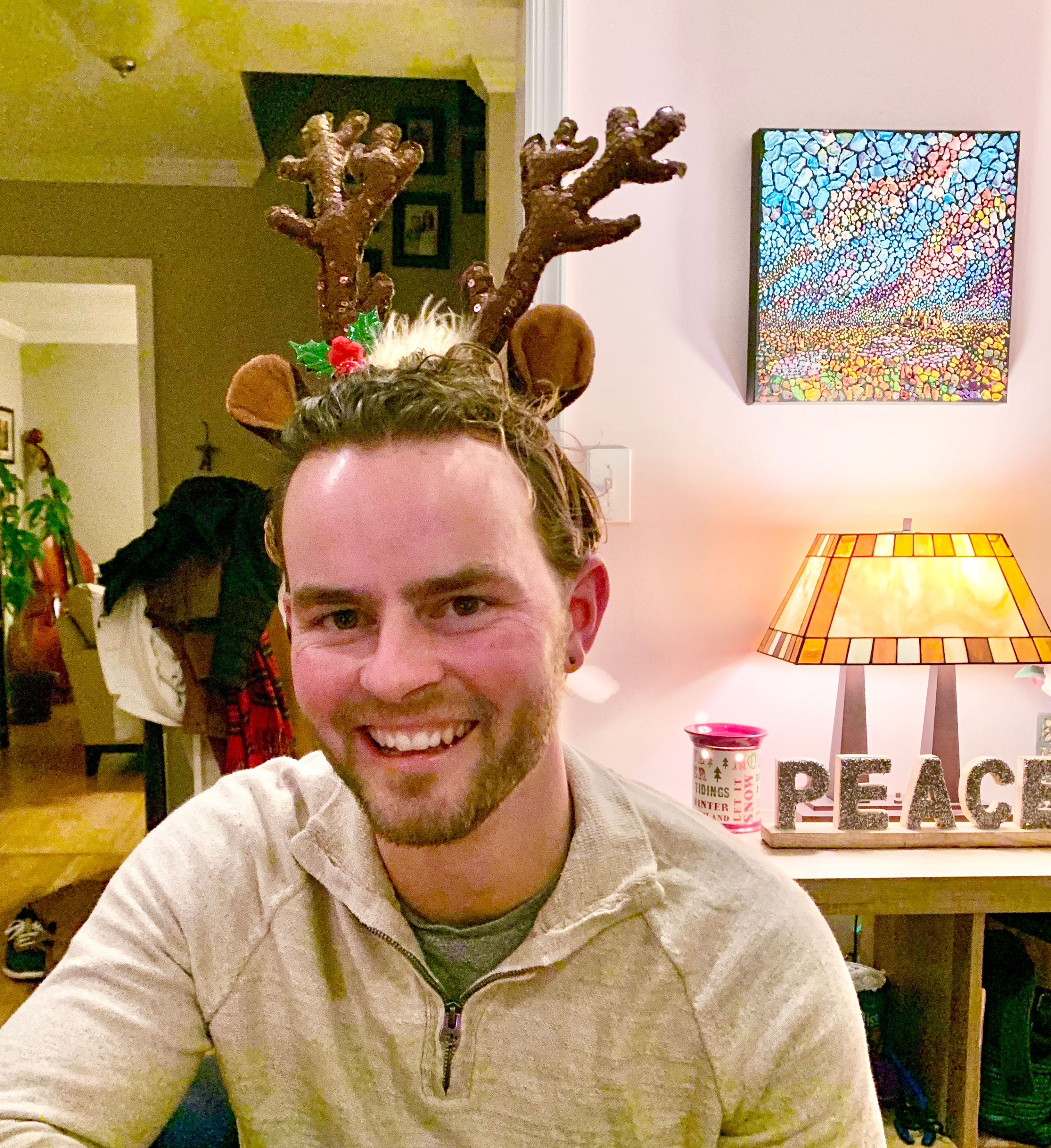 Dr. Nate Reuter wearing reindeer antlers at the program's annual Holiday Party in 2019