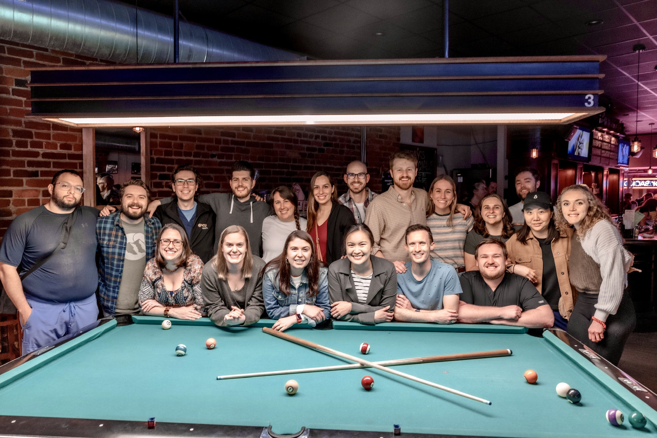 med-peds residents gathered around a pool table